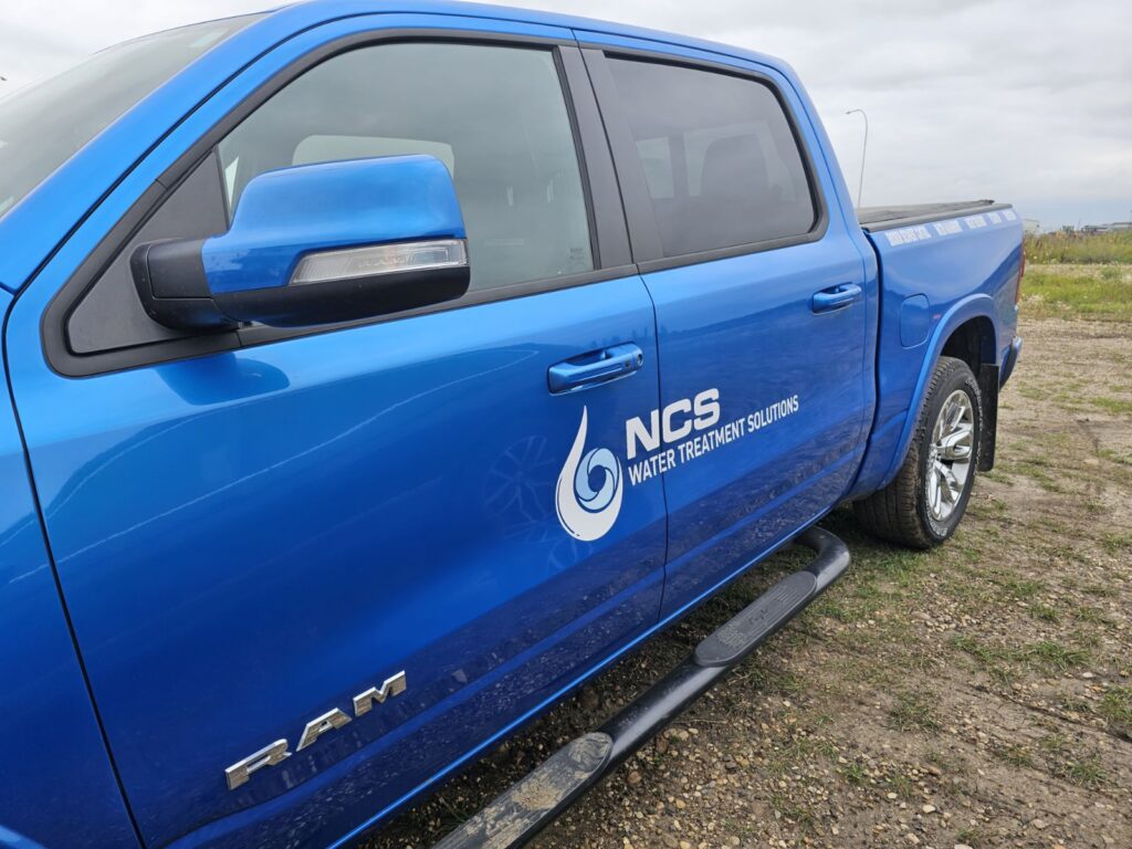 Blue water treatment division truck with NCS logo on it.